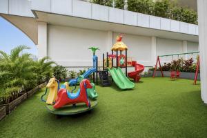 a childrens playground with a slide and a ride at Sunday Hotel Antero Jababeka in Cikarang