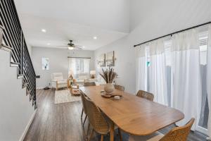 a dining room and living room with a table and chairs at Casa Playa Long Beach in Long Beach