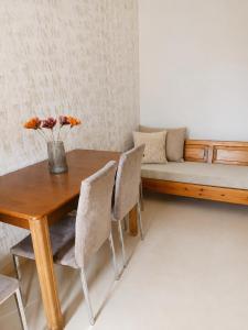 a dining room table with chairs and a couch at Margianna Apartments1 in Káto Ássos +2 photos