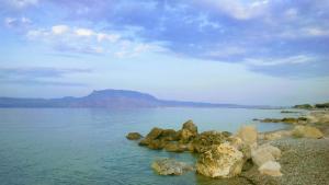 a group of rocks on the shore of a body of water at Margianna Apartments1 in Káto Ássos
