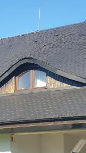 a roof of a house with a window on it at Pensiunea Mușata Bucovinei in Vama