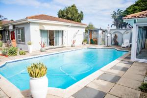 a swimming pool in the backyard of a house at @47 Guest House in Gqeberha