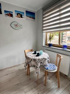 a dining room with a table and two chairs at Maritime Apartment in Świnoujście