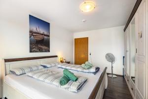 two beds in a room with white walls at bleib. Boutique Fewos Bodensee in Radolfzell am Bodensee