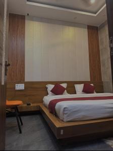 a bedroom with a large bed with red pillows at Deep residency in Bharatpur
