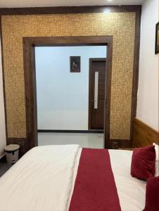 a bedroom with a large bed and a large window at Deep residency in Bharatpur