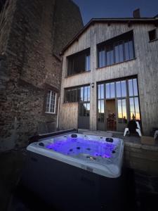 a hot tub with purple lights in front of a building at Maison Saint Christophe in Le Mans