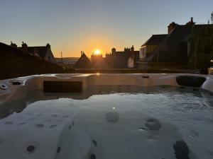 a hot tub with the sunset in the background at Maison Saint Christophe in Le Mans