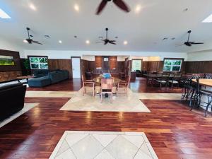 a large living room with a table and chairs at Hale Halai in Hauula