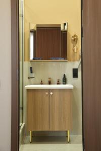 a bathroom with a sink and a mirror at Monteva Boutique Hotel in Almaty +19 photos