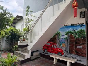 a mural of a red car under the stairs at Baan Chiang Maan in Chiang Mai