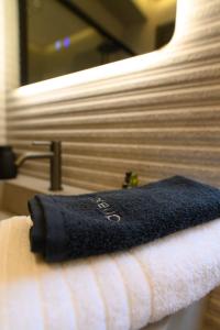 a black towel is sitting on top of a bed at Trilogy Resorts in Alexandroupoli +119 photos