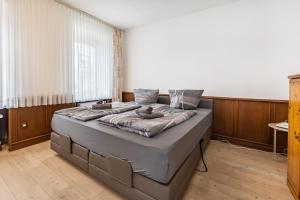 a bedroom with a bed with two stuffed animals on it at Ferienwohnung Ostermann in Plettenberg