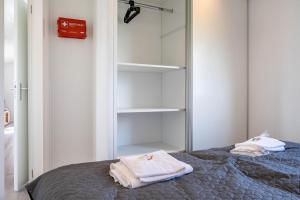 a bedroom with a bed with towels on it at Rapunzel in Dörverden +13 photos