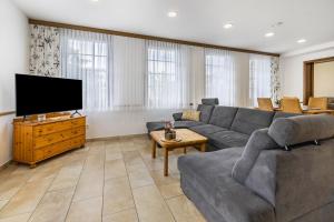 a living room with a couch and a flat screen tv at Ferienwohnung Ostermann in Plettenberg