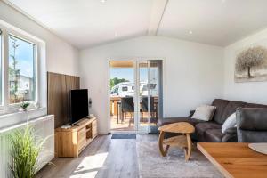 a living room with a couch and a tv at Rapunzel in Dörverden
