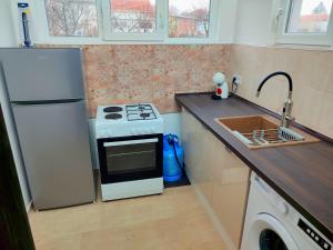 a kitchen with a white stove and a sink at Goranovi House in Pleven