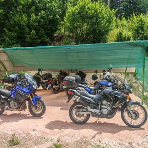 a group of motorcycles parked in a parking lot at Evergreen Motto Sohodol Camping in Sohodol +3 photos