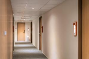 a corridor of an office building with long hallway halls at 休日行旅 Vacay Stay in Tainan