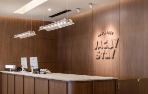 a bathroom with a reception counter and a mirror at 休日行旅 Vacay Stay in Tainan