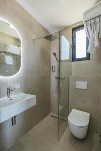 a bathroom with a toilet and a sink and a shower at Majestic Bay in Čanj +23 photos