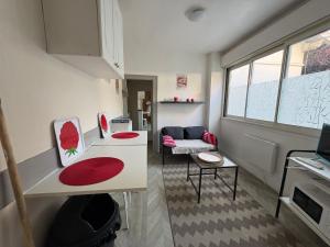 a small room with a kitchen and a living room at studio à deux pas du bassin in Arcachon