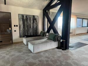 a living room with a couch and a table at Amuse Bouche by Skabrin in Bansko