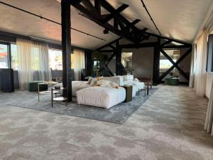 a bedroom with a bed and tables and windows at Amuse Bouche by Skabrin in Bansko