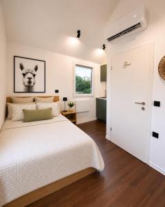 a bedroom with a large white bed and a window at Aktivurlaub im Schwarzwald Natur Sport und Erholung in Efringen-Kirchen