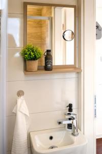 a bathroom with a sink and a mirror at Aktivurlaub im Schwarzwald Natur Sport und Erholung in Efringen-Kirchen