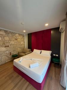 a bedroom with a large bed and a couch at Monarch Beach in Borsh
