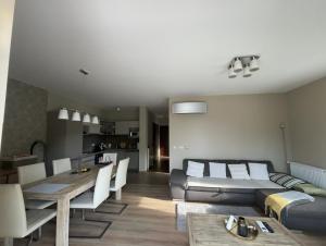 a living room with a couch and a table at Panorama Apartman Zamardi in Zamárdi