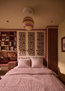 a bedroom with a bed with a striped bedspread at LangX Ecopark Sky Forest - Dolce Apartment in Kim Quan +5 photos