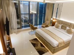 a bedroom with a large bed and a large window at HOTEL LAWANG SIGNAGE in Deoghar