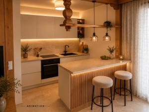 a kitchen with a counter and two bar stools at Haus Stöckl Top 14 in Königsleiten