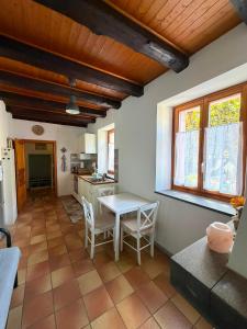 a kitchen with a table and chairs in a room at Il Nido Viola in Arbedo-Castione +10 photos
