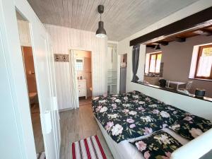 a bedroom with a bed with a floral comforter at Il Nido Viola in Arbedo-Castione