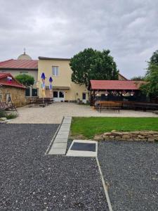 a building with a picnic area with benches and tables at Apartmány BRETZ in Vrbov
