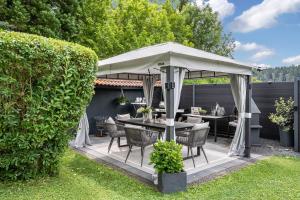 a gazebo with a table and chairs under it at Ferienglück Vogelsang in Loßburg