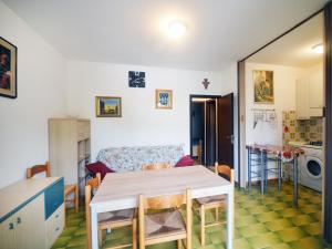 a kitchen and living room with a table and a couch at SIT Holiday Homes in Lido delle Nazioni