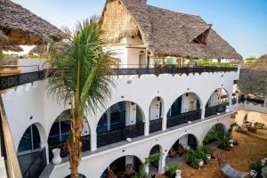 an aerial view of a building with a palm tree at Nyota Boutique Hotel Zanzibar in Nungwi
