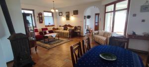 a living room with a couch and a table at Felföldi Tanyavendégház in Kiskunmajsa