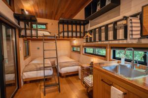 a bedroom with bunk beds in a tiny house at Tiny Base in Kawazu +27 photos