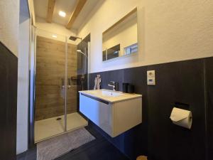 a bathroom with a sink and a shower at Scheuneria, Gästehaus in Dockweiler +34 photos