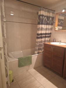 a bathroom with a tub and a sink and a bath tub at Au Vieux Séchoir in Prudhomat +18 photos