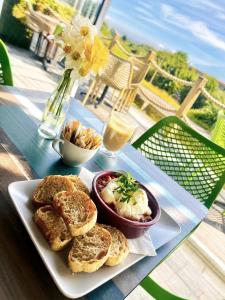 a table with a plate of bread and a bowl of food at North Devon Resort in Ilfracombe