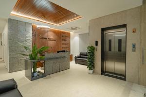 an office with a lobby with a door and plants at Crown Residency in Kanyakumari