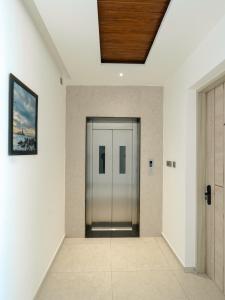 a hallway with a glass door in a building at Crown Residency in Kanyakumari +12 photos