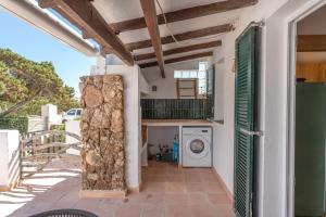 a laundry room with a washer and dryer in a house at Villas 19 Estrellas in Cala en Bosc