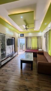 a living room with a couch and a table at M2 lambardaar in Dehradun